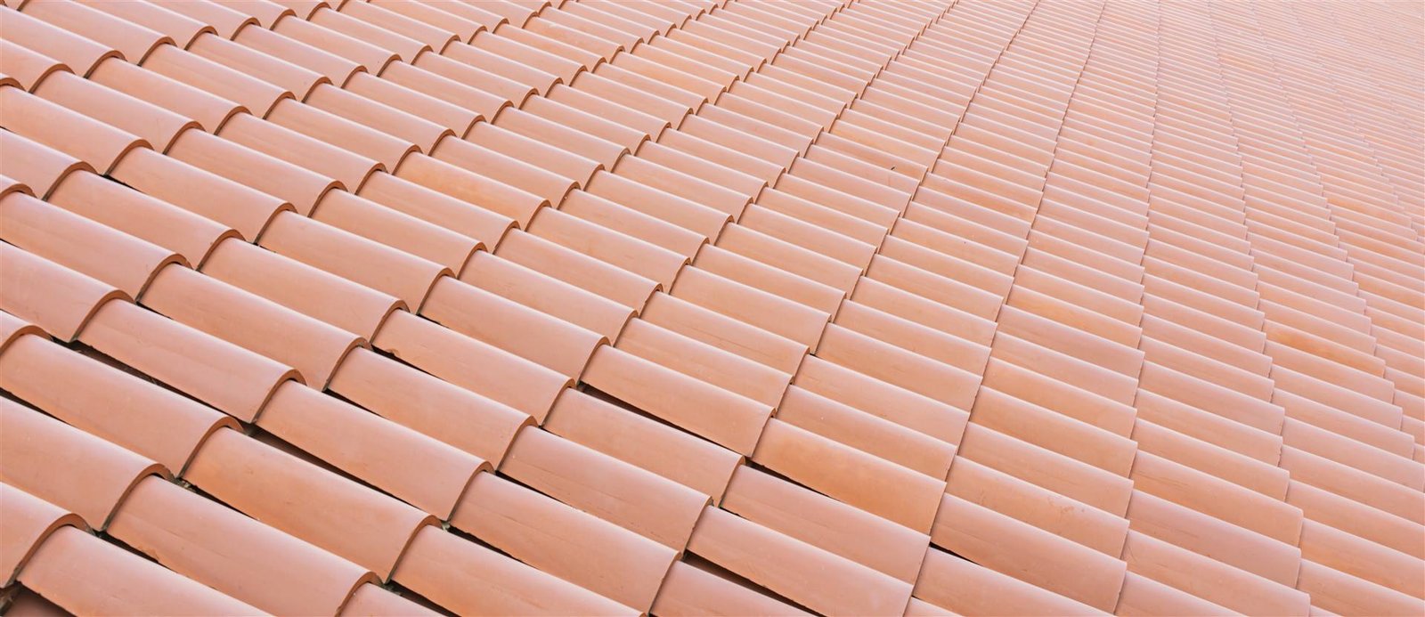 Close view of overlapping terracotta roof tiles from Rain Right Roofing’s website